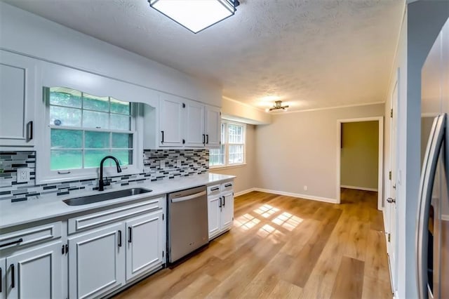 516 Jordan Dr NW, Tucker, GA 30084 - kitchen featuring dishwasher, decorative backsplash, light countertops, and a textured ceiling