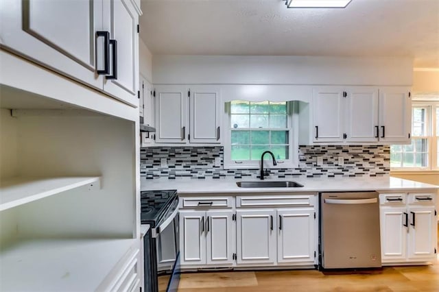 516 Jordan Dr NW, Tucker, GA 30084 - kitchen featuring stainless steel appliances, light countertops, light wood finished floors, and white cabinetry