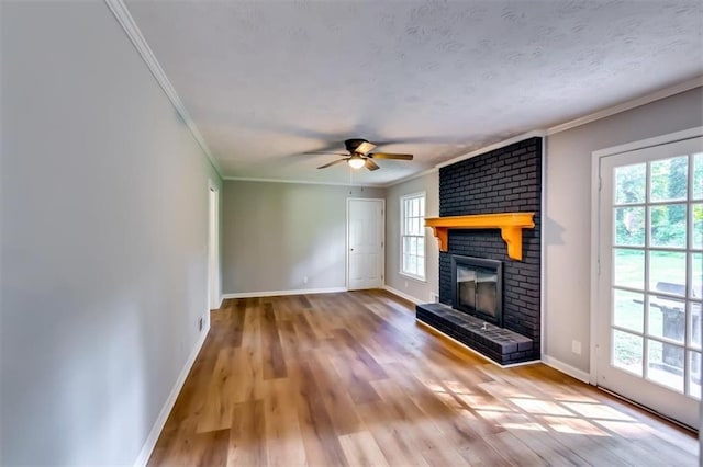 516 Jordan Dr NW, Tucker, GA 30084 - unfurnished living room with crown molding, a brick fireplace, wood finished floors, and a ceiling fan