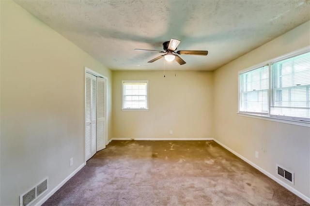 516 Jordan Dr NW, Tucker, GA 30084 - unfurnished bedroom with carpet floors, a closet, and a ceiling fan