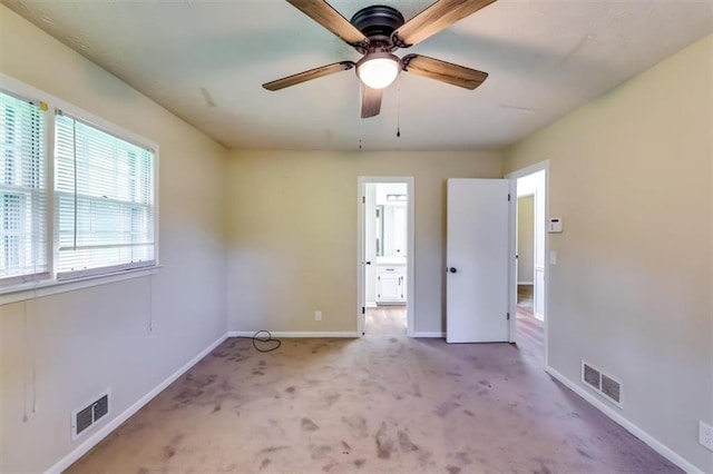 516 Jordan Dr NW, Tucker, GA 30084 - unfurnished bedroom with light carpet, connected bathroom, and ceiling fan