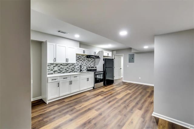 516 Jordan Dr NW, Tucker, GA 30084 - kitchen featuring stainless steel electric range, freestanding refrigerator, extractor fan, electric panel, and white cabinets