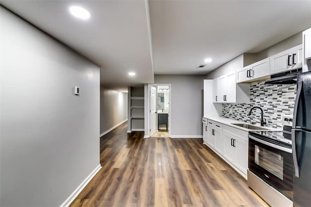 516 Jordan Dr NW, Tucker, GA 30084 - kitchen with electric stove, tasteful backsplash, white cabinetry, light countertops, and recessed lighting