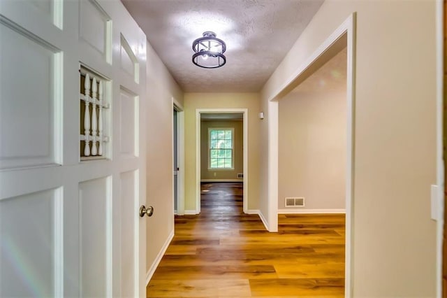 516 Jordan Dr NW, Tucker, GA 30084 - hallway with light wood-style floors and a textured ceiling