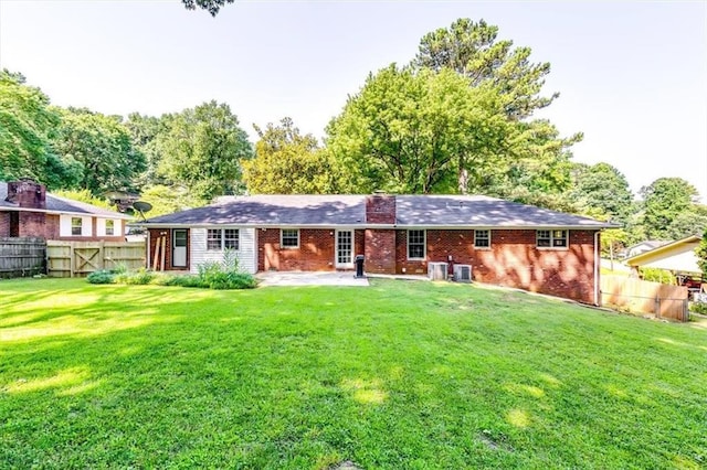 516 Jordan Dr NW, Tucker, GA 30084 - back of property with a patio area, brick siding, and a chimney