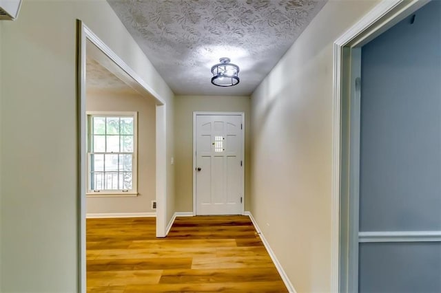 516 Jordan Dr NW, Tucker, GA 30084 - doorway to outside with wood finished floors and a textured ceiling
