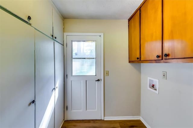 516 Jordan Dr NW, Tucker, GA 30084 - washroom featuring cabinet space, washer hookup, and wood finished floors