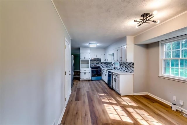 516 Jordan Dr NW, Tucker, GA 30084 - kitchen with stainless steel appliances, light countertops, decorative backsplash, white cabinetry, and a textured ceiling