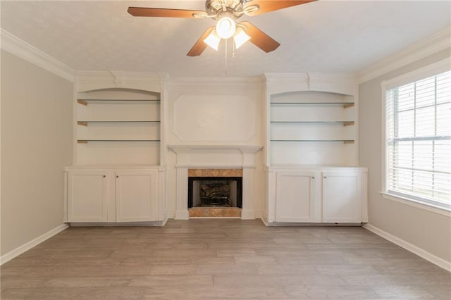 6683 Princeton Park Ct, Lithonia, GA 30058 - unfurnished living room with ceiling fan, a fireplace, plenty of natural light, light wood-type flooring, and crown molding