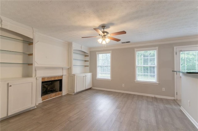 6683 Princeton Park Ct, Lithonia, GA 30058 - unfurnished living room with a ceiling fan, light wood-style flooring, a premium fireplace, a textured ceiling, and baseboards