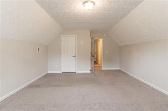 6683 Princeton Park Ct, Lithonia, GA 30058 - bonus room with a textured ceiling, carpet flooring, lofted ceiling, and baseboards