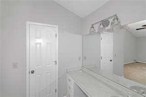 bathroom featuring vaulted ceiling