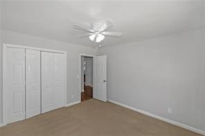 unfurnished bedroom featuring a closet, a ceiling fan, and baseboards