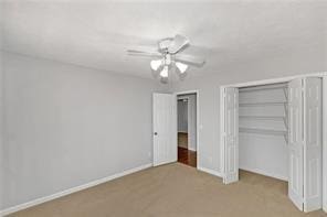 unfurnished bedroom featuring baseboards, a ceiling fan, a closet, and carpet flooring