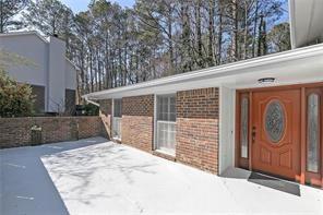 property entrance featuring brick siding