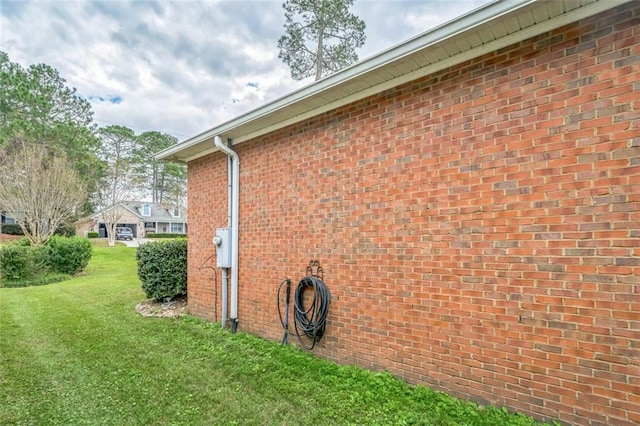 view of side of home featuring a yard