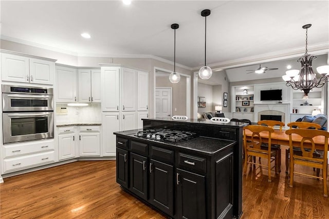 2759 Thomashire Trce, Marietta, GA 30066 - kitchen featuring black gas stovetop, stainless steel double oven, dark cabinetry, ornamental molding, and white cabinets
