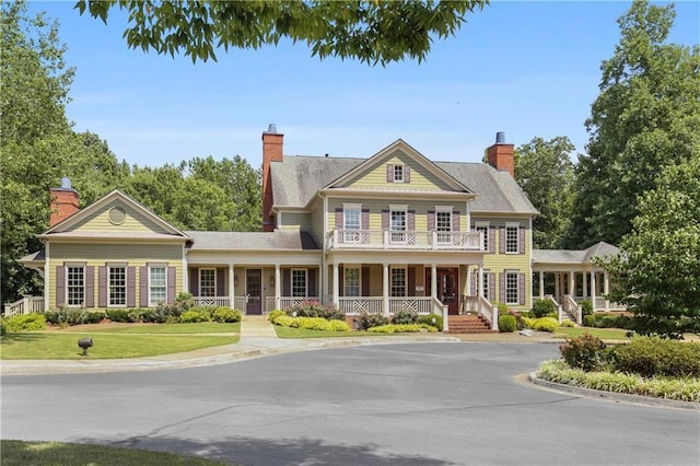 2759 Thomashire Trce, Marietta, GA 30066 - view of front of home featuring covered porch, a balcony, a chimney, and a front yard