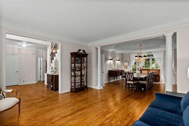 2759 Thomashire Trce, Marietta, GA 30066 - living area with wood finished floors, a chandelier, ornamental molding, stairs, and decorative columns