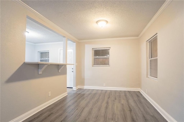 2817 Burton Rd NW, Atlanta, GA 30311 - empty room with a textured ceiling, dark wood finished floors, crown molding, and baseboards