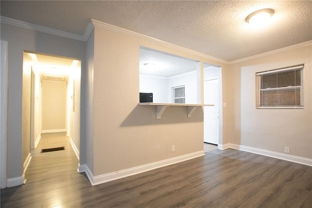 2817 Burton Rd NW, Atlanta, GA 30311 - unfurnished room featuring dark wood-style flooring, a textured ceiling, crown molding, and baseboards