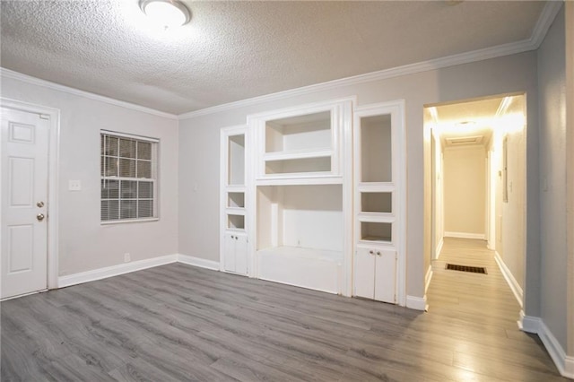 2817 Burton Rd NW, Atlanta, GA 30311 - unfurnished dining area with wood finished floors, ornamental molding, baseboards, and a textured ceiling