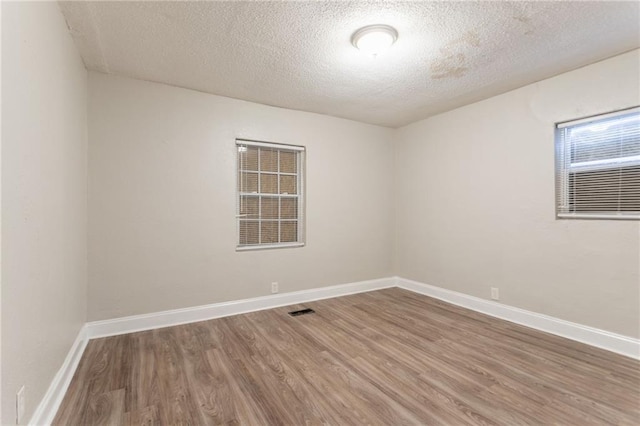 2817 Burton Rd NW, Atlanta, GA 30311 - spare room featuring wood finished floors, a textured ceiling, and baseboards