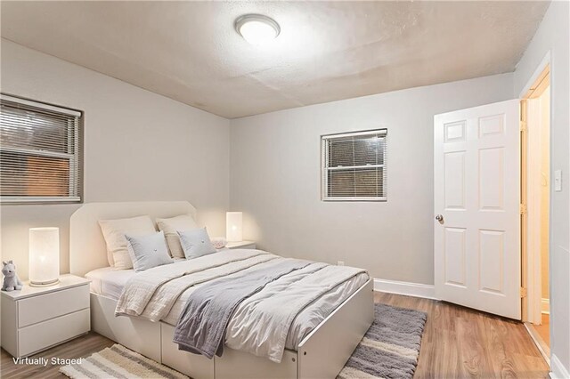 2817 Burton Rd NW, Atlanta, GA 30311 - bedroom featuring light wood-style flooring and baseboards