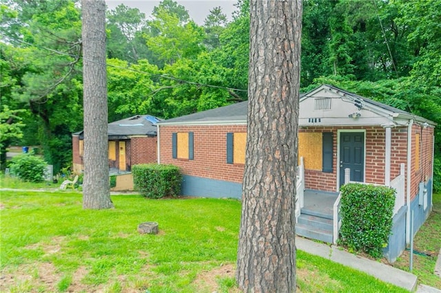 2817 Burton Rd NW, Atlanta, GA 30311 - view of front facade with covered porch, brick siding, and a front yard