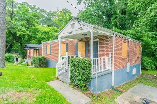 2817 Burton Rd NW, Atlanta, GA 30311 - bungalow-style home featuring a porch, brick siding, and a front lawn