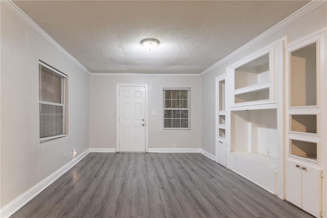 2817 Burton Rd NW, Atlanta, GA 30311 - unfurnished room featuring dark wood-type flooring, a textured ceiling, ornamental molding, and baseboards