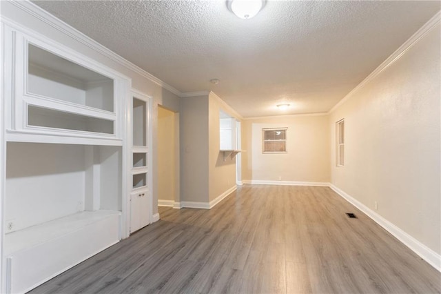 2817 Burton Rd NW, Atlanta, GA 30311 - unfurnished living room with wood finished floors, a textured ceiling, ornamental molding, and baseboards