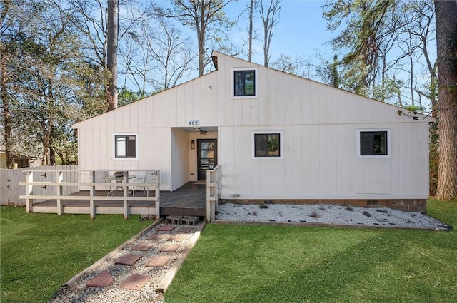 view of front of house with crawl space, fence, a deck, and a front yard