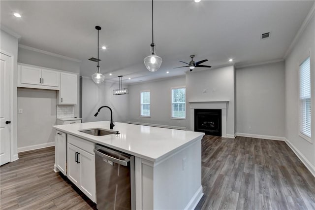kitchen featuring dishwasher, a sink, ceiling fan, crown molding, and white cabinetry