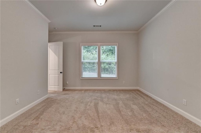 carpeted spare room with crown molding and baseboards