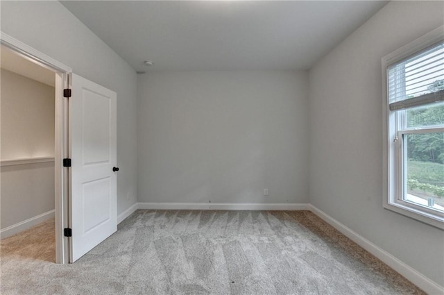 unfurnished bedroom featuring carpet flooring and baseboards