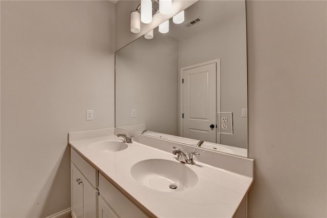 full bathroom with double vanity and baseboards