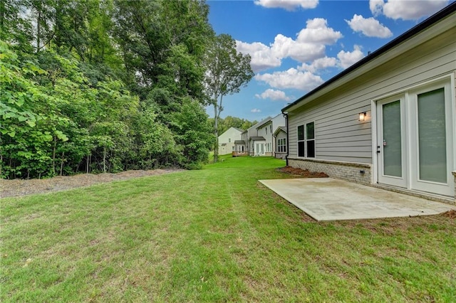 view of grassy yard with a patio
