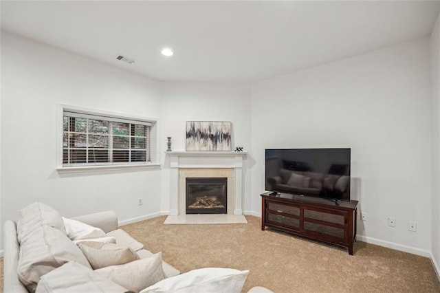 carpeted living room featuring recessed lighting, baseboards, a premium fireplace, and visible vents