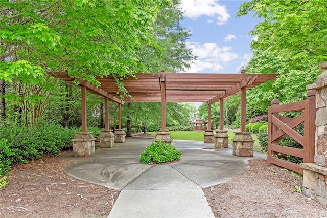 view of property's community featuring a pergola and a patio area
