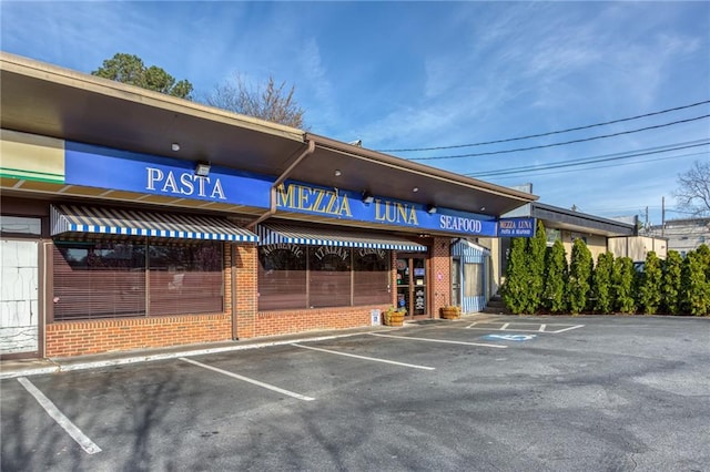 view of building exterior with uncovered parking