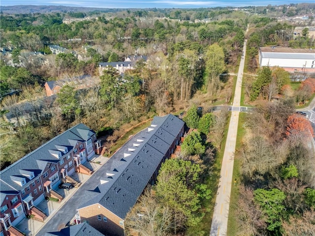 drone / aerial view with a wooded view