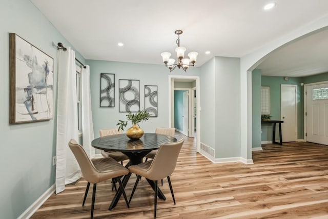 1977 Wee Kirk Rd SE, Atlanta, GA 30316 - dining room with arched walkways, light wood-style floors, baseboards, recessed lighting, and a chandelier
