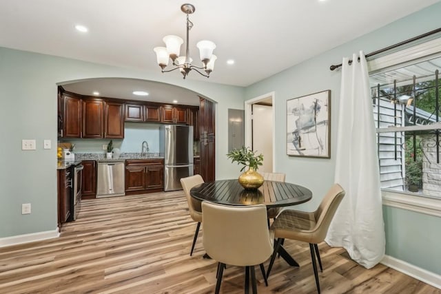 1977 Wee Kirk Rd SE, Atlanta, GA 30316 - dining space with light wood-type flooring, baseboards, a chandelier, recessed lighting, and arched walkways