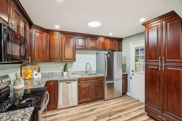 1977 Wee Kirk Rd SE, Atlanta, GA 30316 - kitchen featuring stainless steel appliances, a sink, light wood-style flooring, light stone counters, and recessed lighting