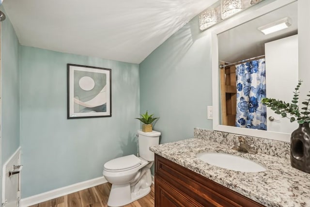 1977 Wee Kirk Rd SE, Atlanta, GA 30316 - bathroom featuring wood finished floors, toilet, vanity, curtained shower, and baseboards