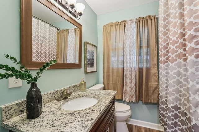 1977 Wee Kirk Rd SE, Atlanta, GA 30316 - kitchen with appliances with stainless steel finishes, arched walkways, a sink, light wood-style flooring, and light stone counters