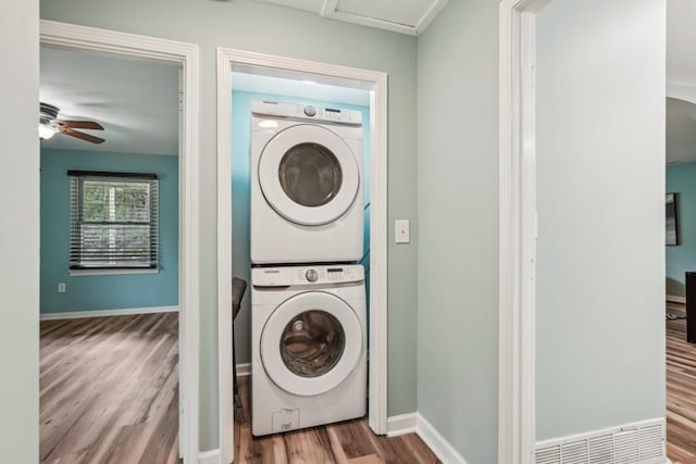 1977 Wee Kirk Rd SE, Atlanta, GA 30316 - laundry area with stacked washer and clothes dryer, wood finished floors, ceiling fan, and baseboards