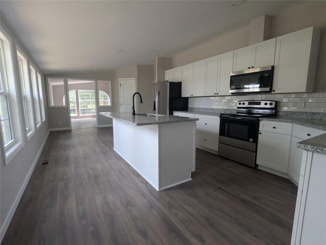 732 Five Points Rd, Buchanan, GA 30113 - kitchen with appliances with stainless steel finishes, backsplash, dark wood-style floors, and white cabinets