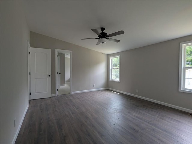732 Five Points Rd, Buchanan, GA 30113 - unfurnished bedroom with multiple windows, dark wood-style floors, and a ceiling fan